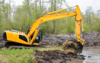 pond building mistakes - construction going on in a pond concept image.