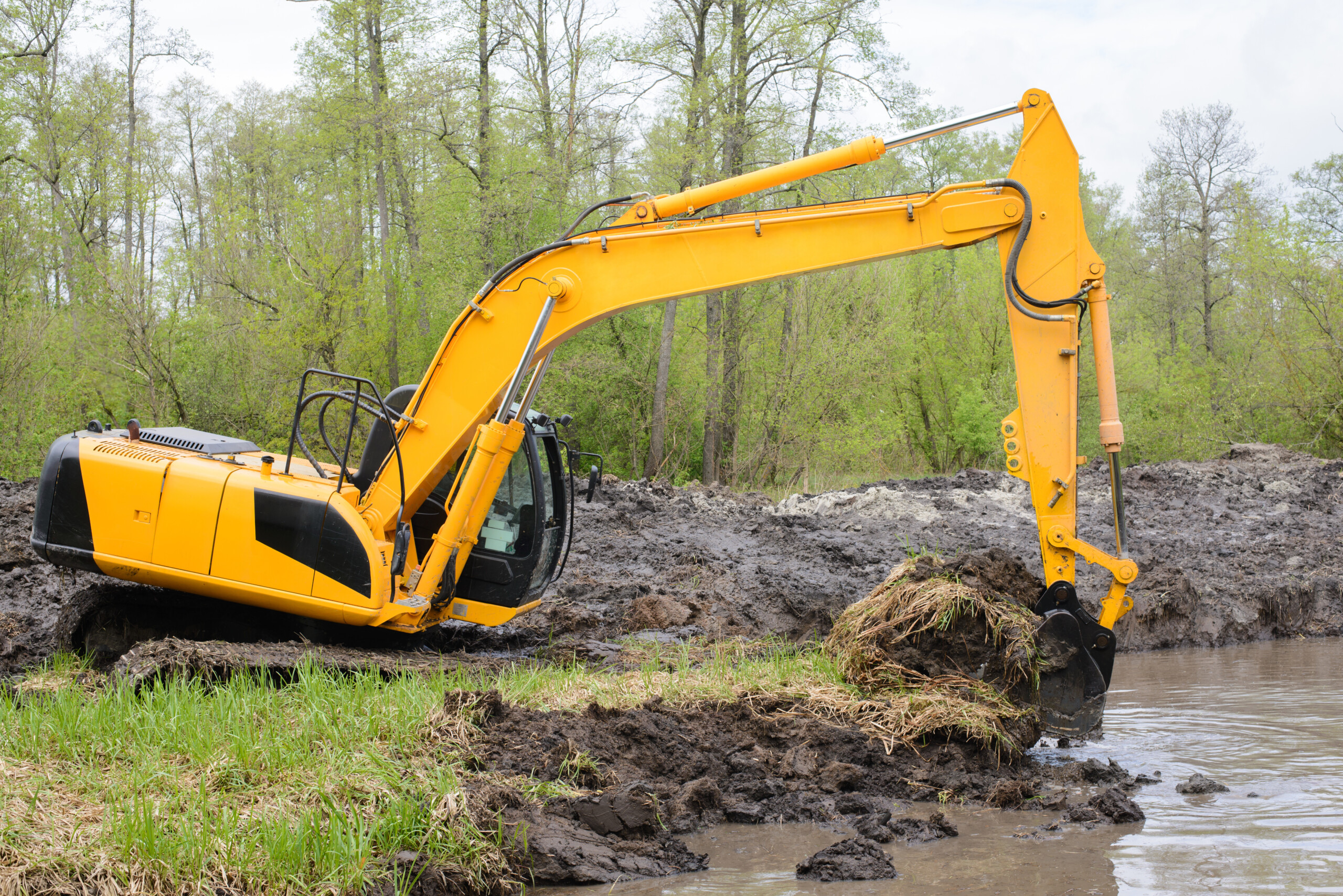pond building mistakes - construction going on in a pond concept image.